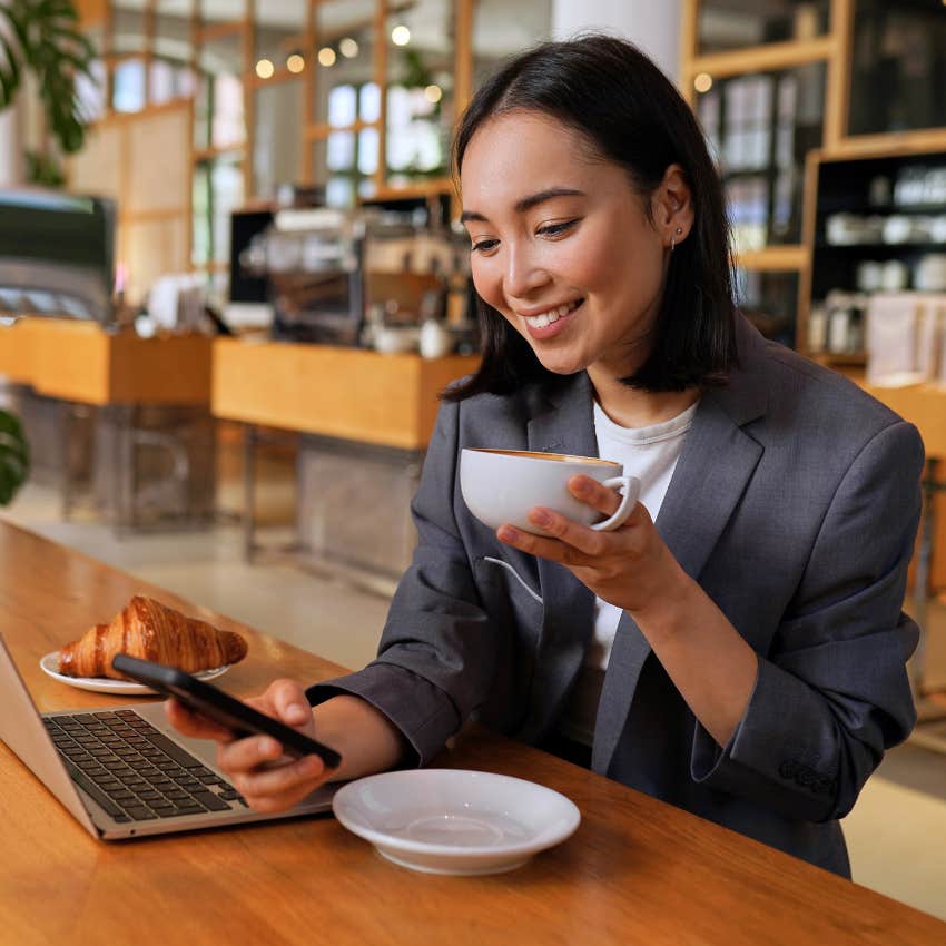 Salaried employee working remotely from coffee shop. 