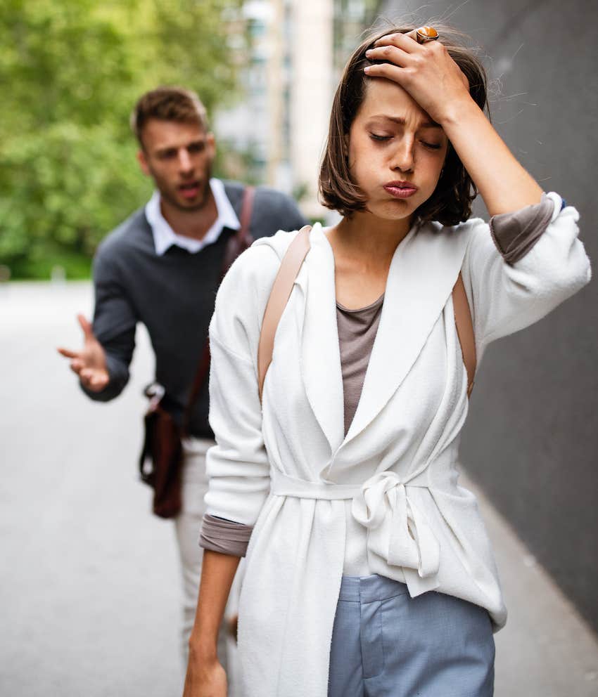 Frustrated woman walks away before she dumps him