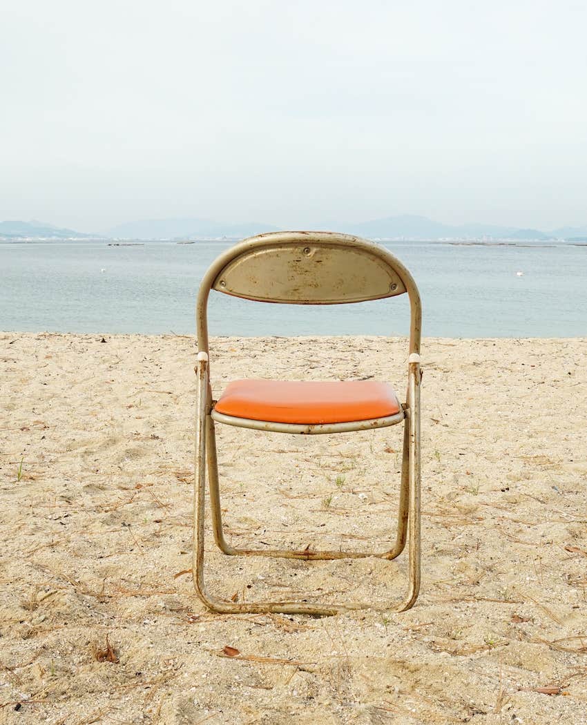 Empty chair in barren land