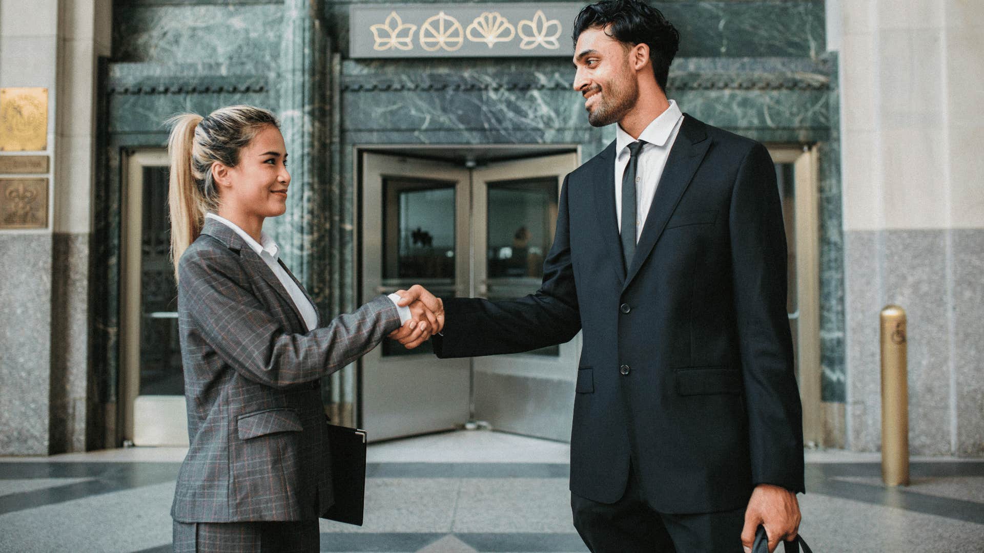 coworkers shaking hands after making decision