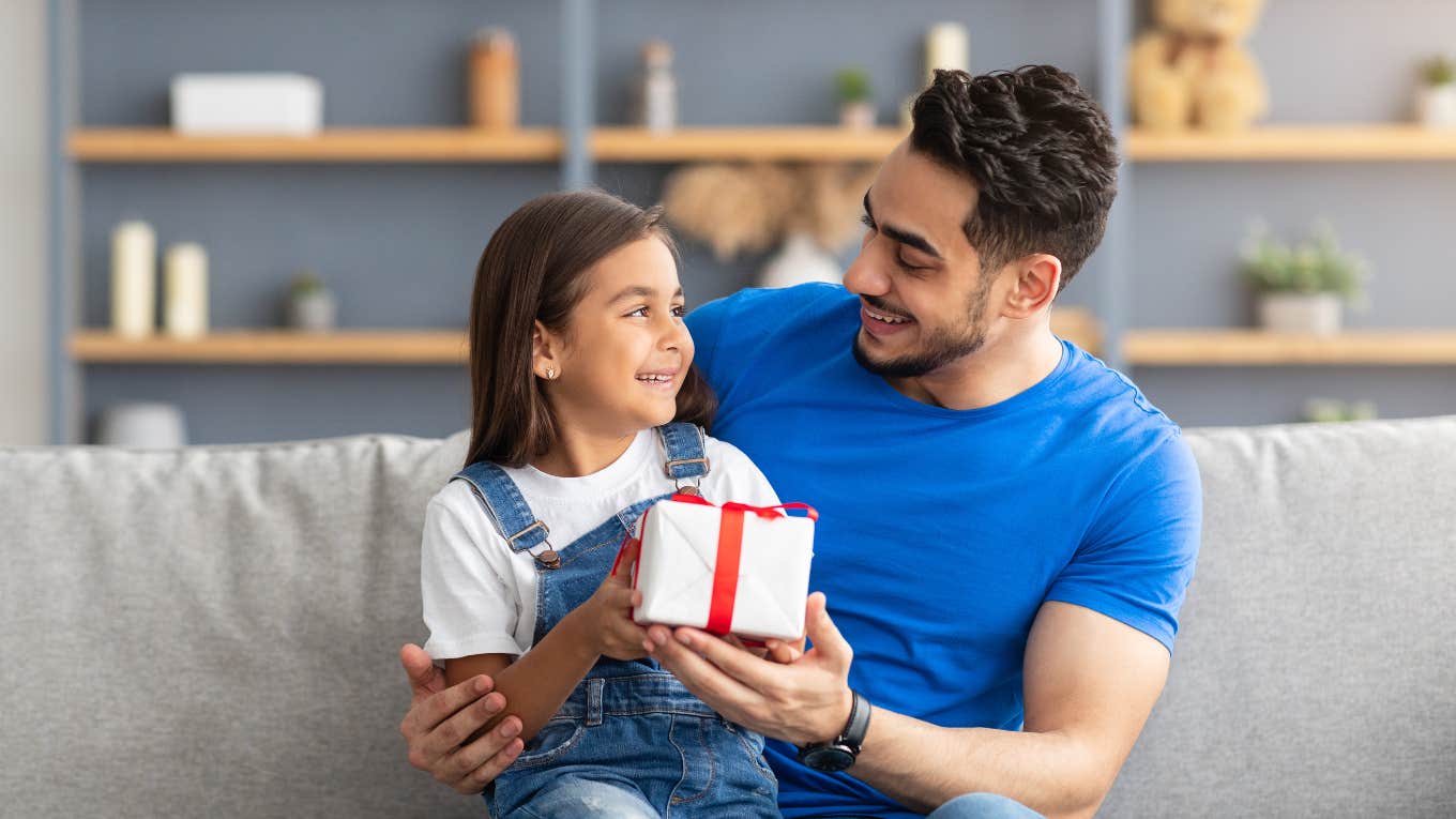 daughter giving father a gift