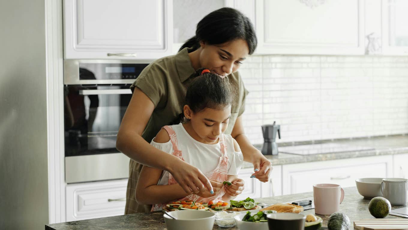 mom and daughter cooking together 