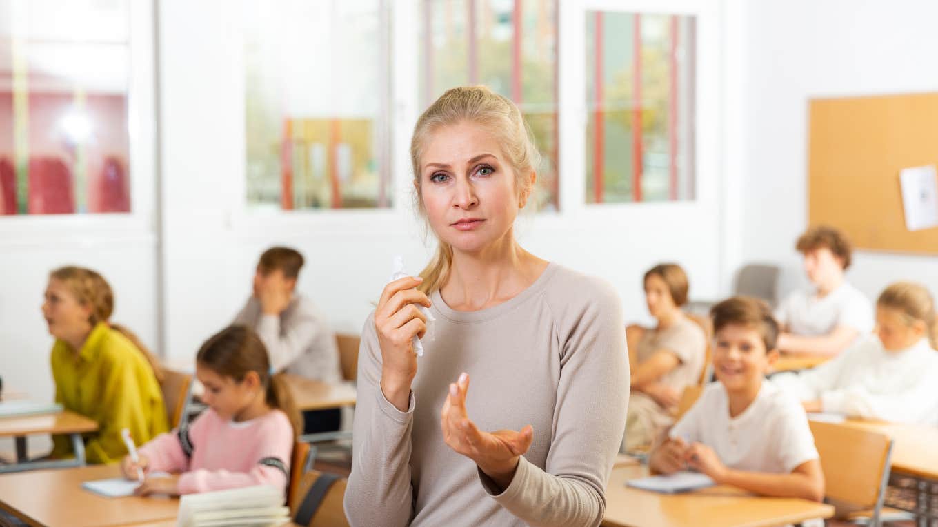 frustrated teacher in classroom full of students