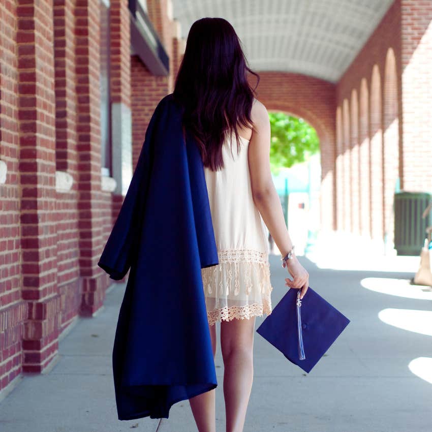 student carrying cap and gown before graduation ceremony