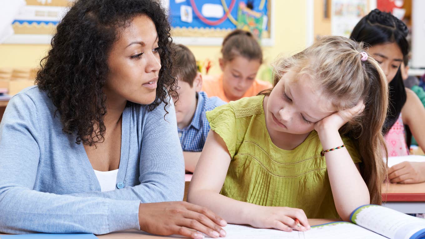 teacher helping a student with assignment