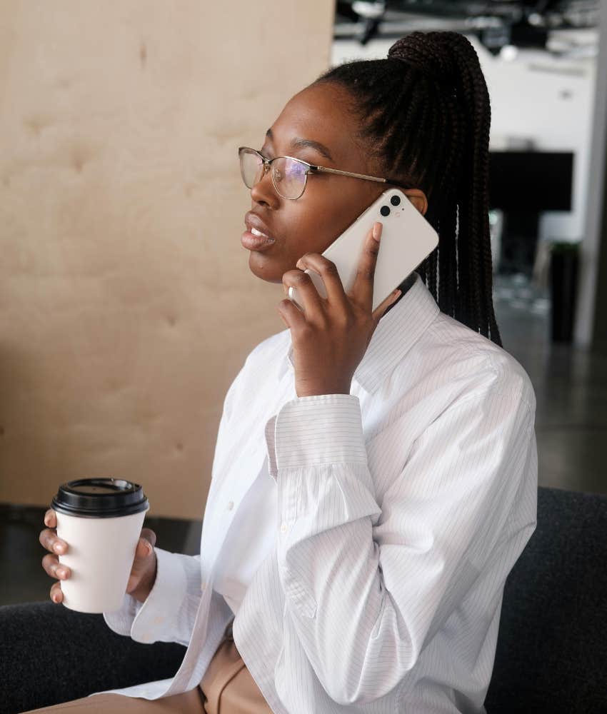 woman talking on phone holding coffee
