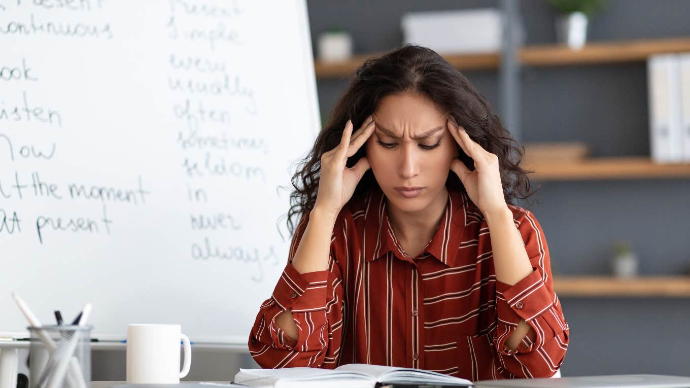 Teacher looking stressed out over her 7th grade student. 