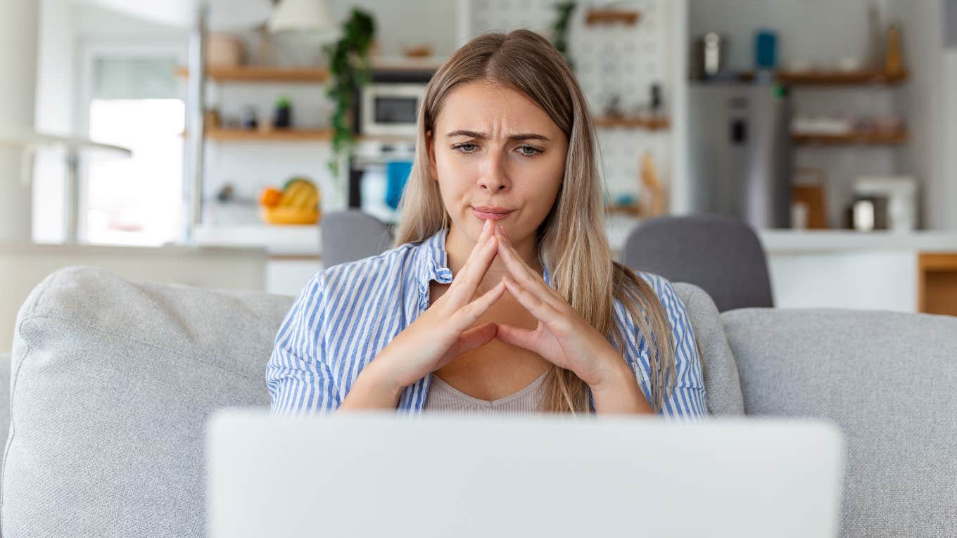 Confused mom reading an email from her son's teacher