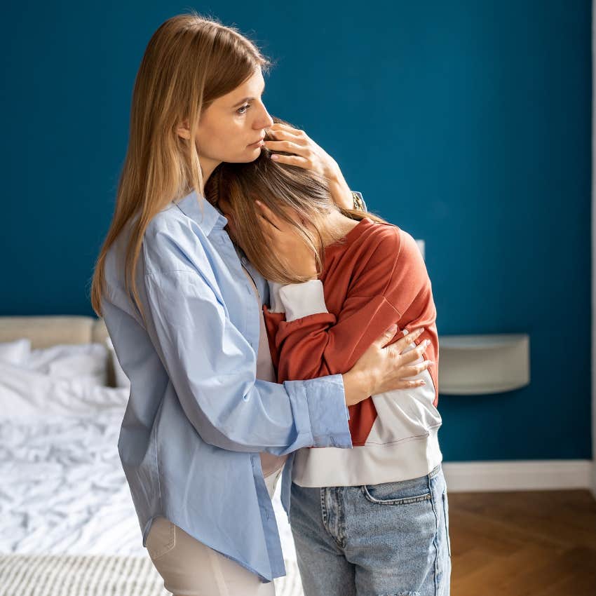 Teenage girl hugging her mom. 