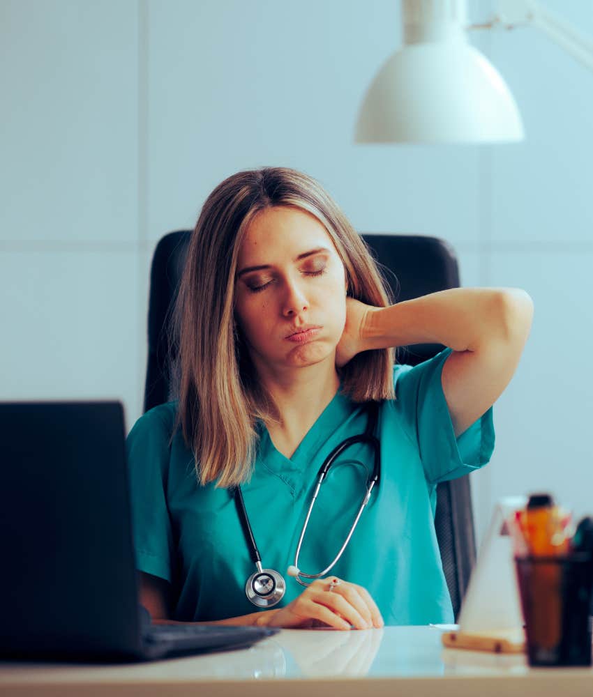 stressed out nurse sitting at desk 