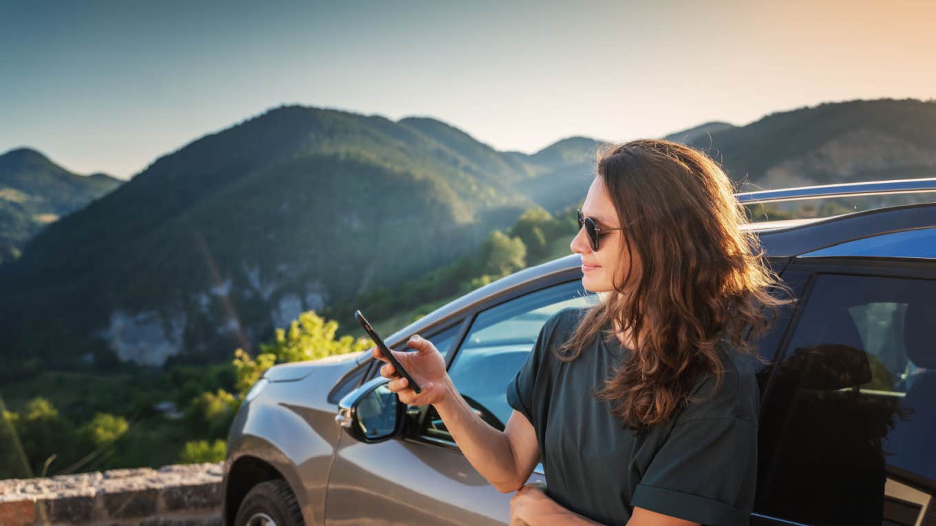 happy woman traveling pulls over to capture beauty