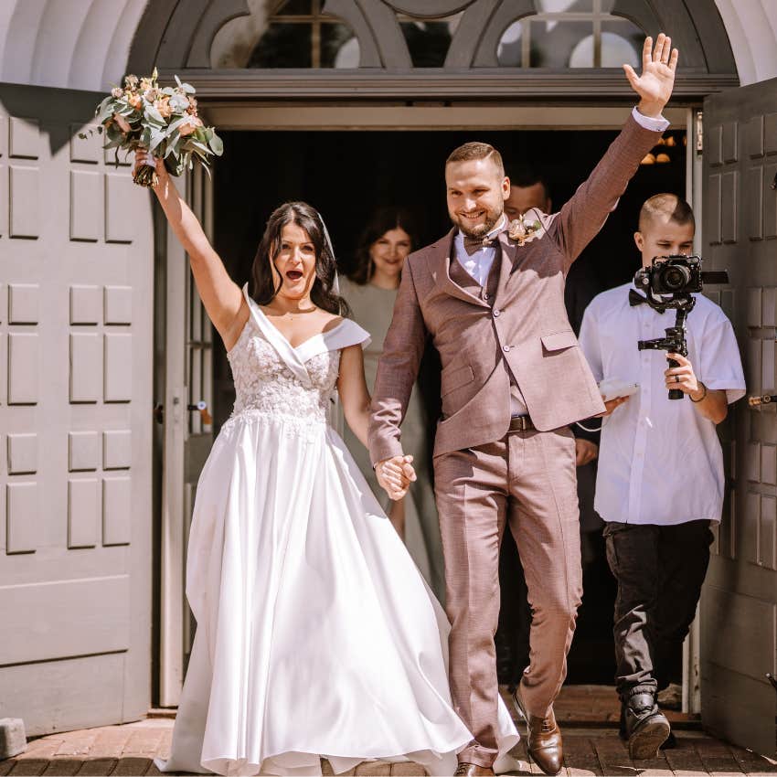 The bride and groom leave the ceremony with wedding guests. 