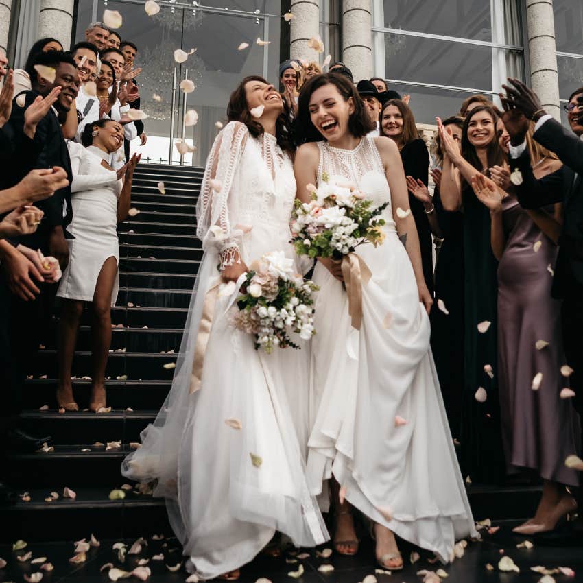 Newlyweds walk out of their ceremony towards the reception. 