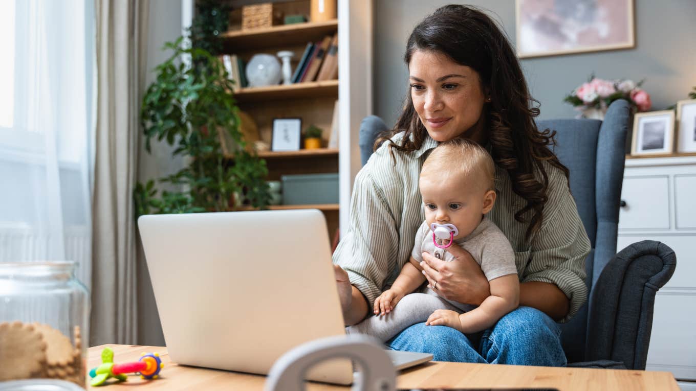 stay-at-home mom working on laptop with baby sitting on her lap