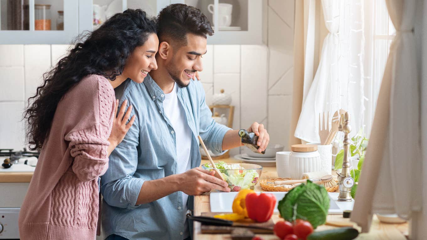 Husband and wife cooking dinner