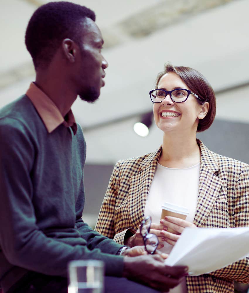 woman smiling while talking with co-worker