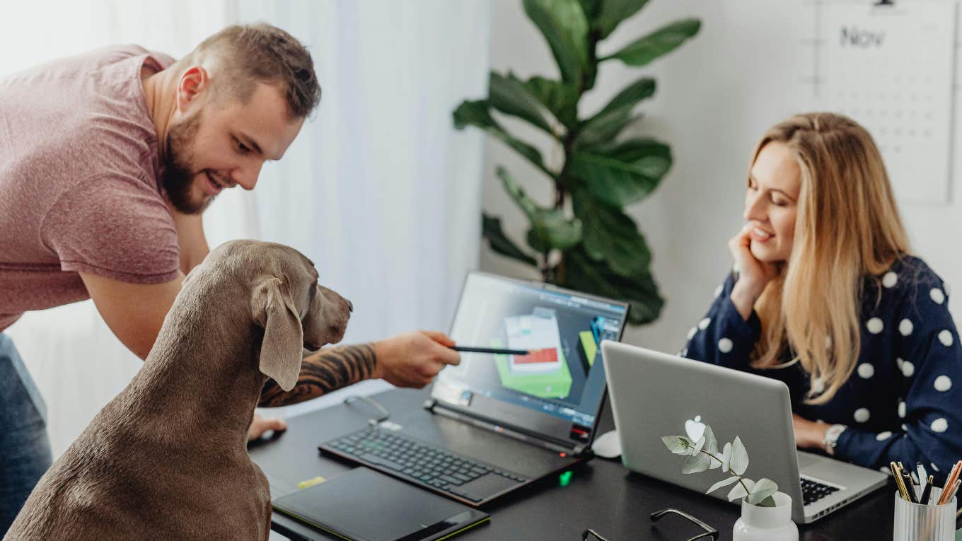 coworkers in an office with a dog