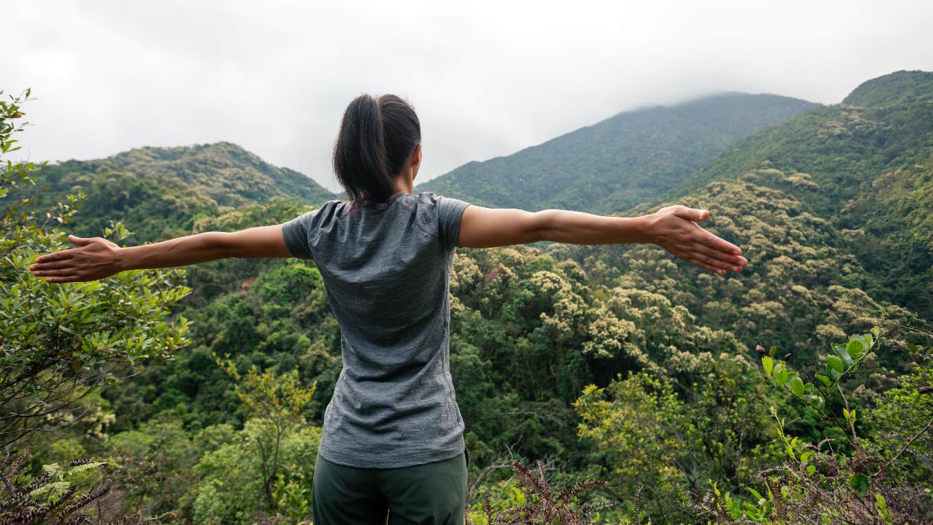 Woman standing on mountain top