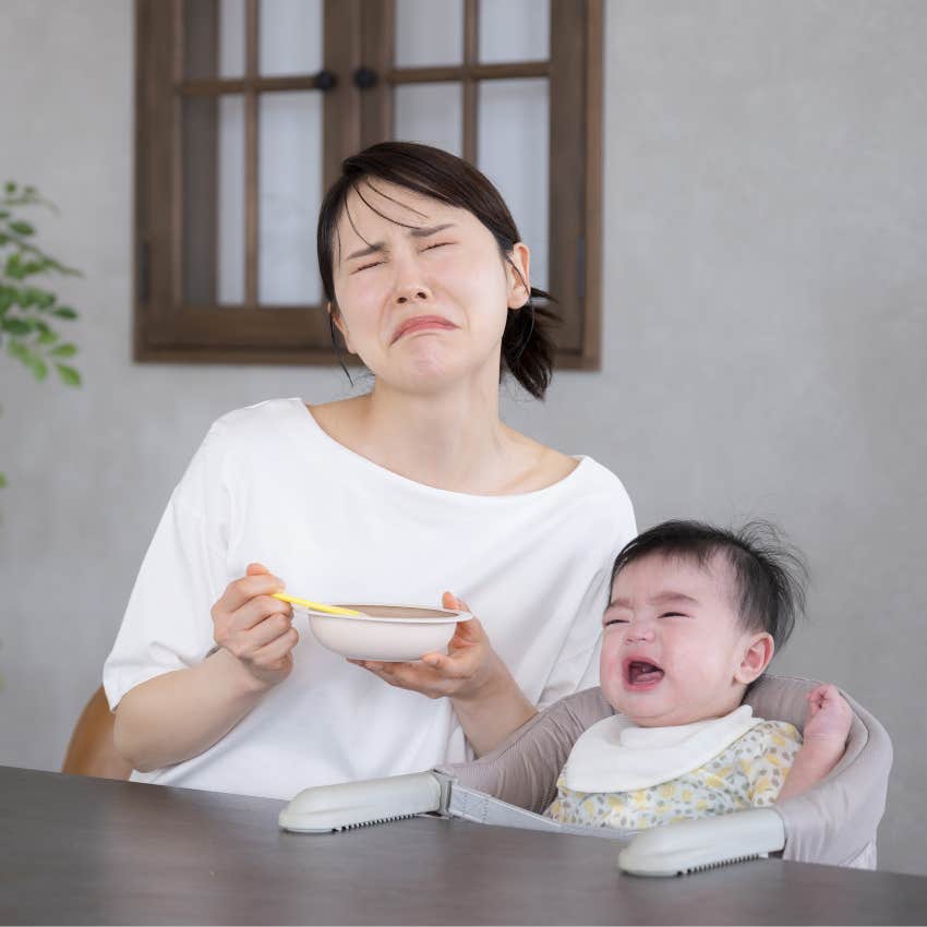 Woman sitting with her fussy baby outside of a job interview. 