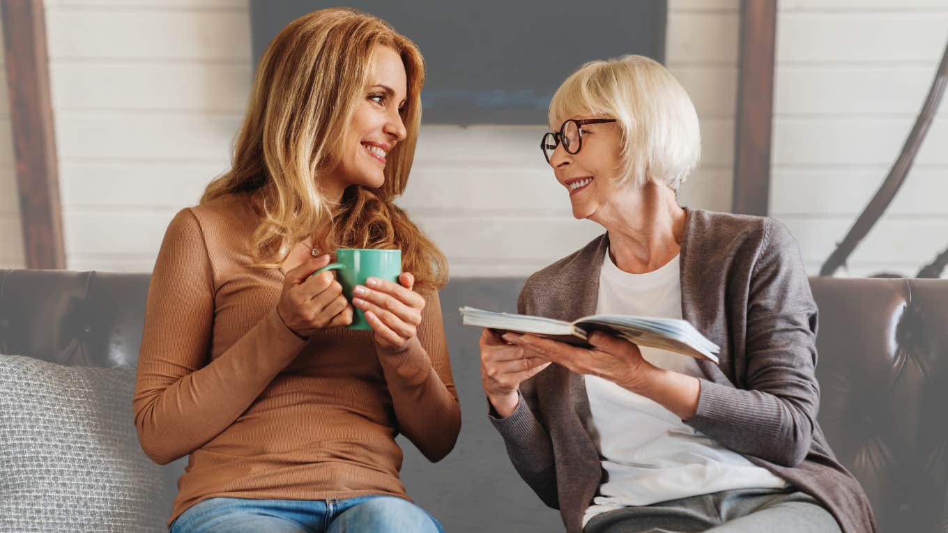 Woman sitting with her grandma eating Chick-fil-A on the couch. 