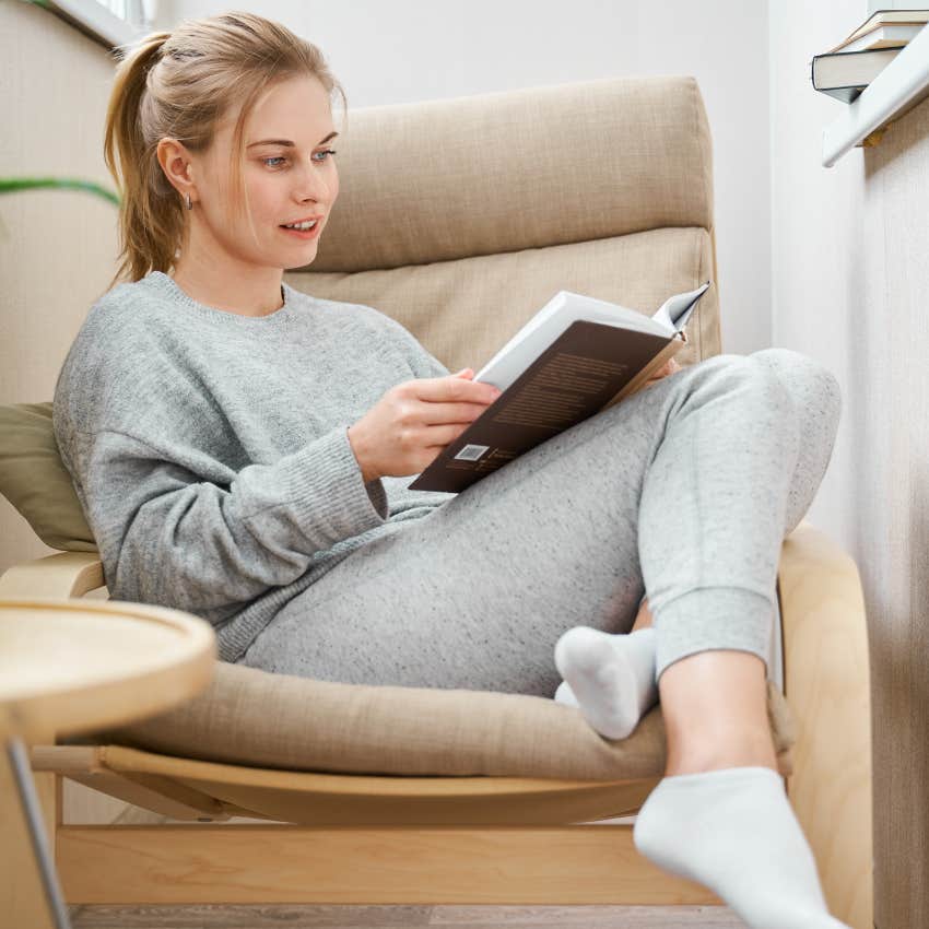 Woman reading in her chair instead of watching short-form content. 