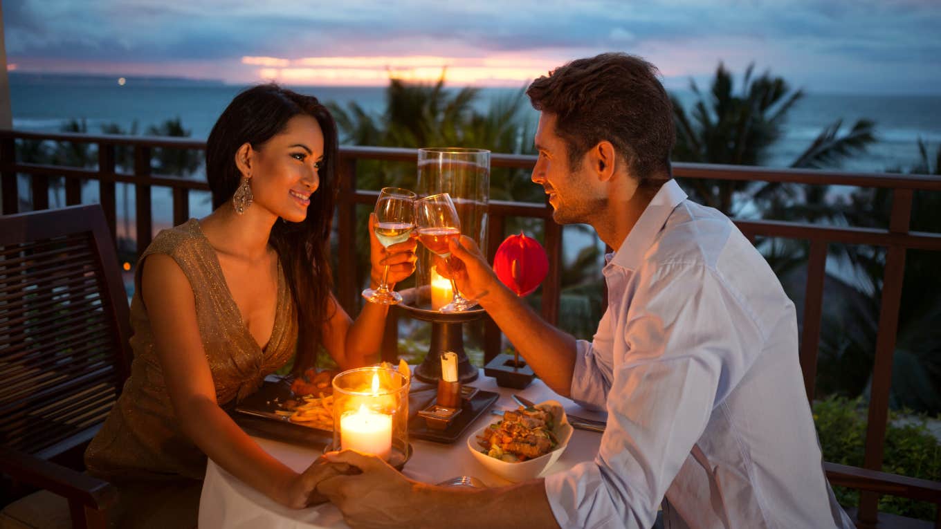 couple on a romantic candlelit date outside during sunset