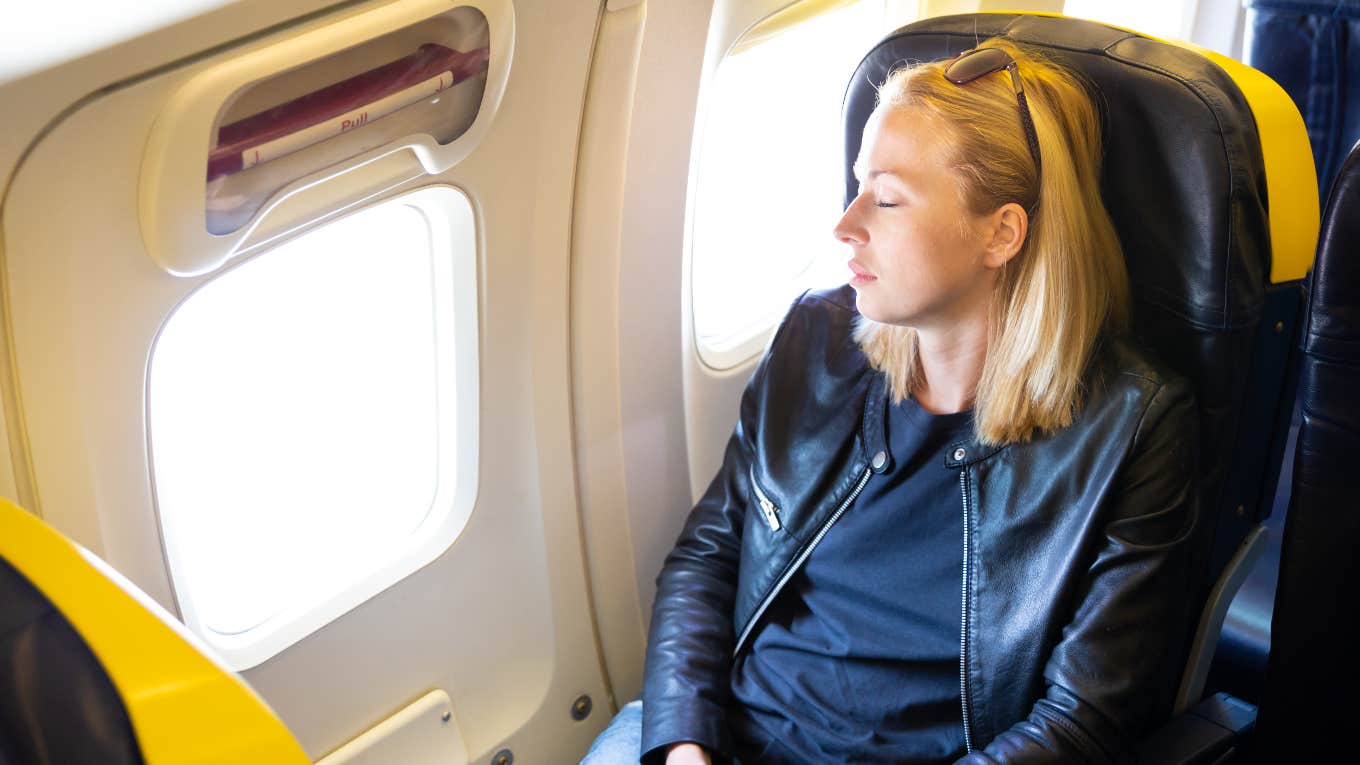 Woman sleeping in exit row of plane