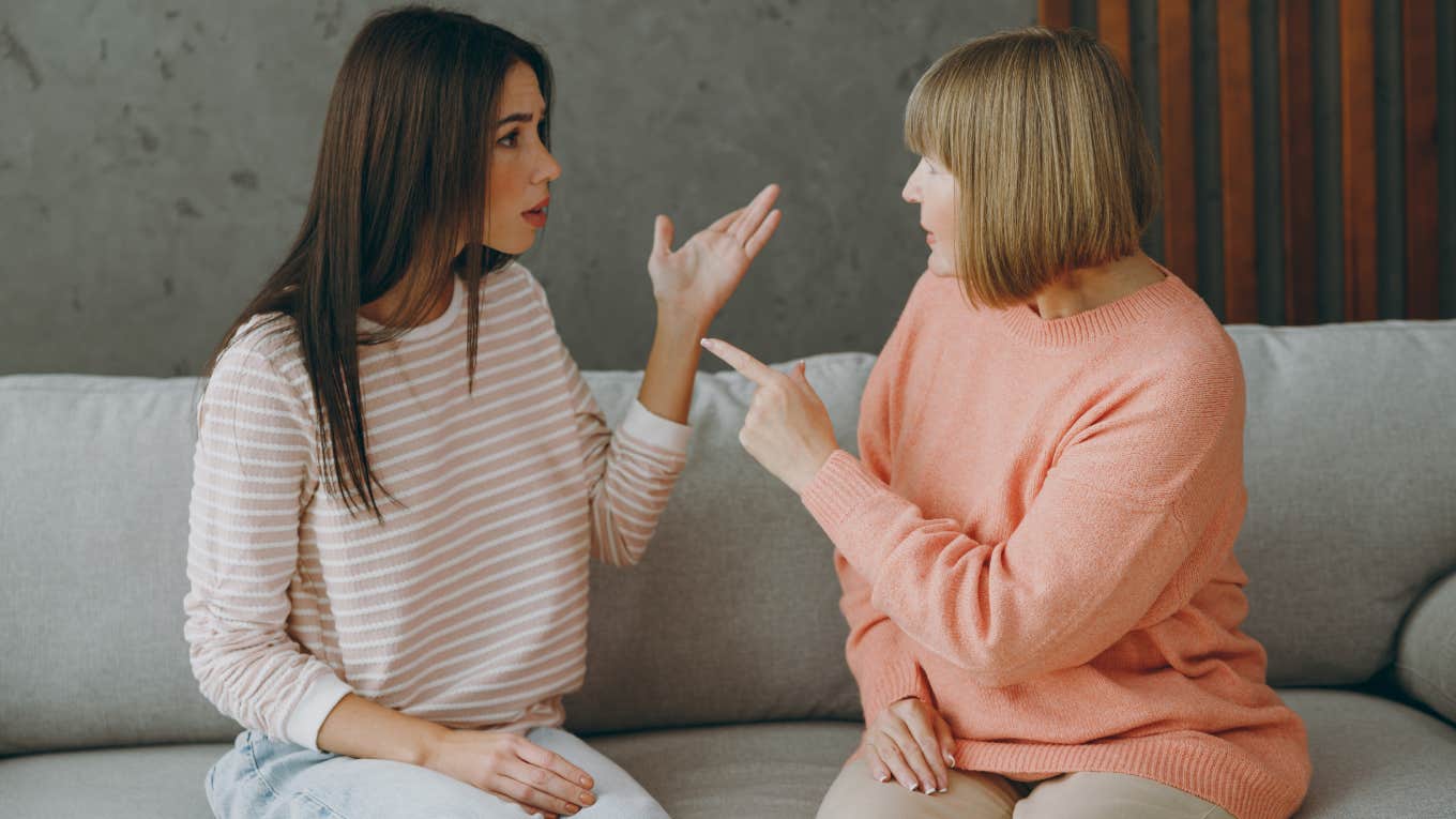 adult women arguing while sitting on couch