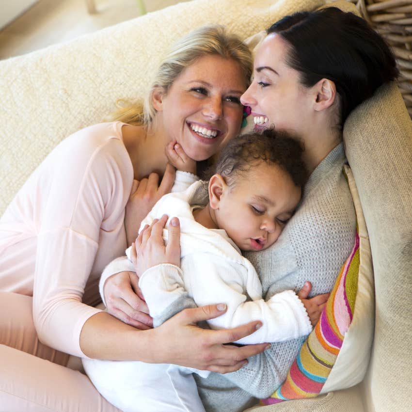 two moms with a baby