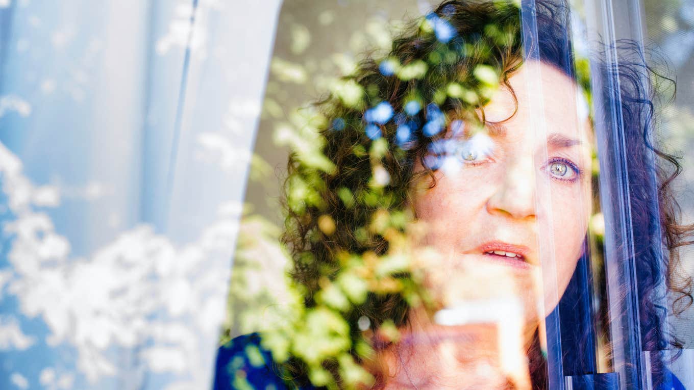 shocked woman looking out her window