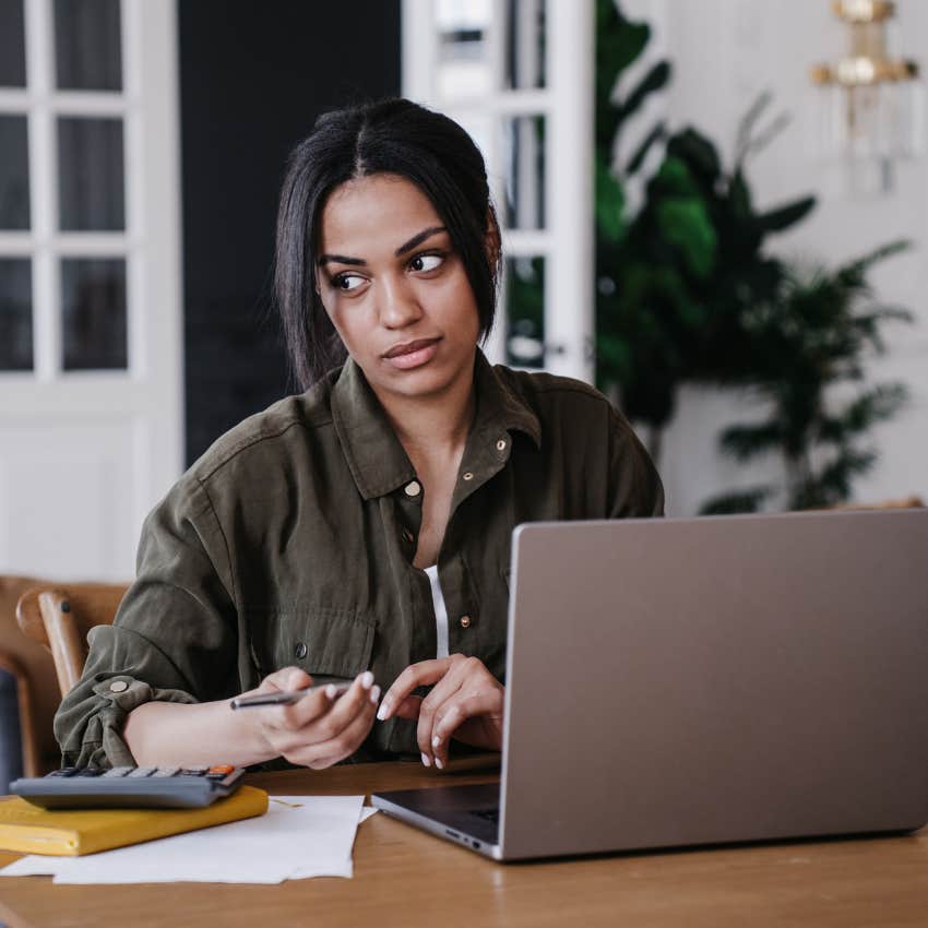 Salaried worker sitting at her desk and working. 