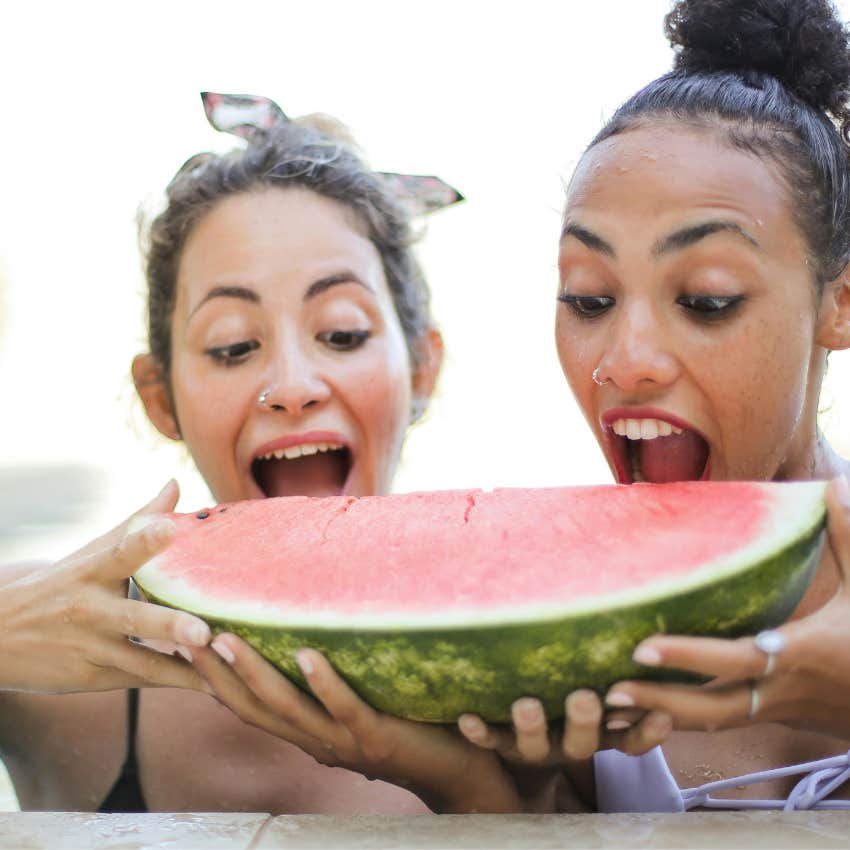 two women eating watermelon