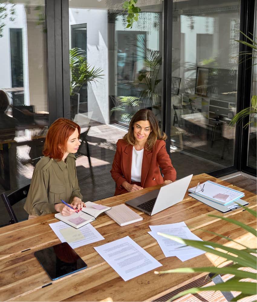 two female coworkers talking 