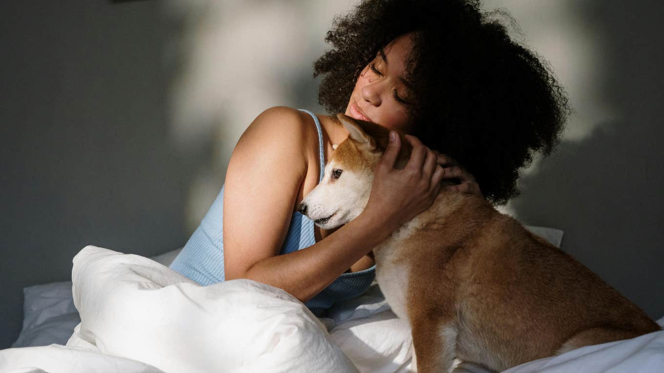 woman with dog in bed