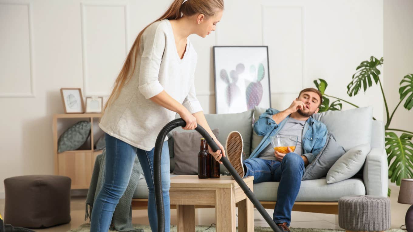 mom cleaning house after work while husband relaxes