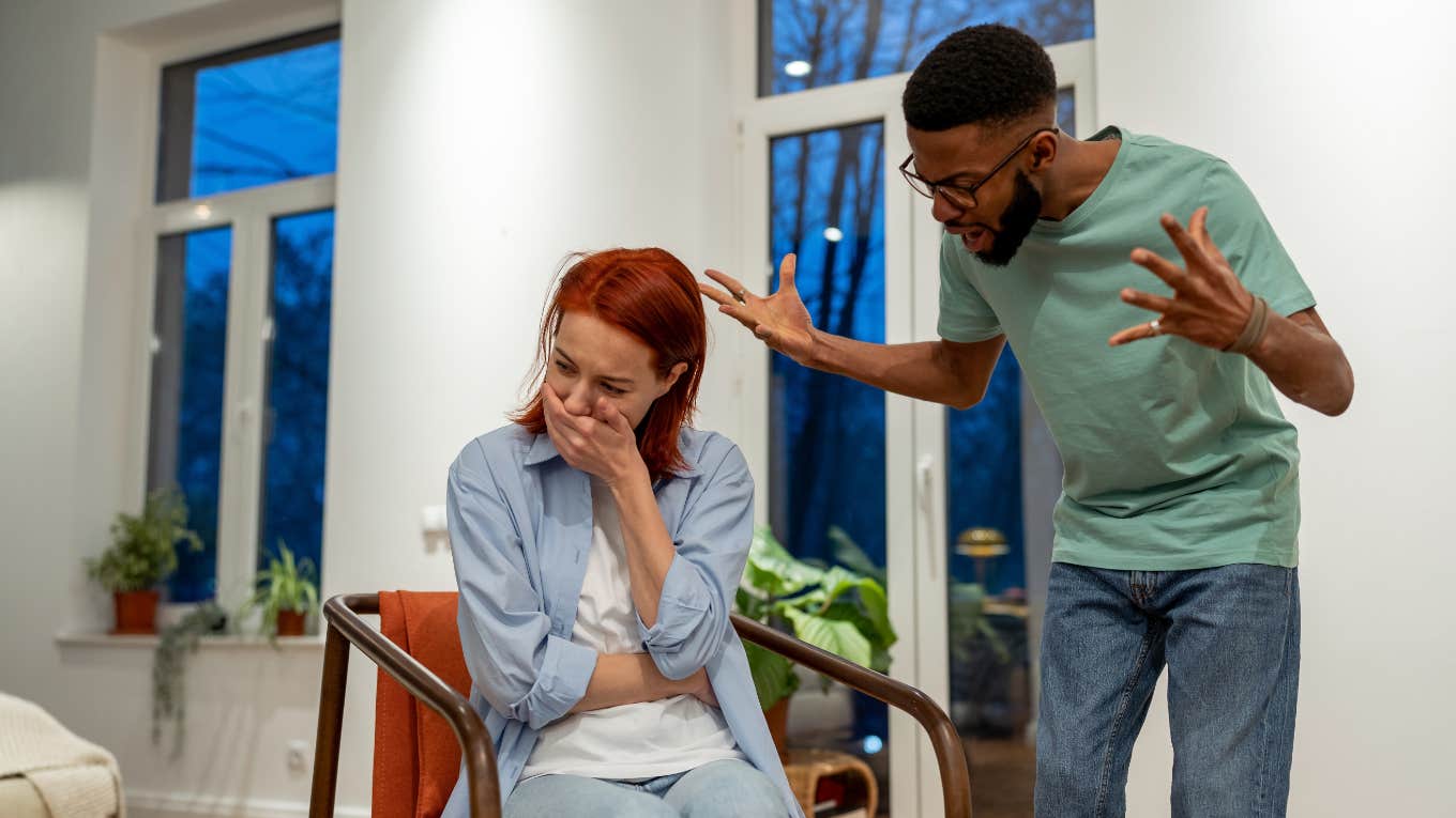 man yells at emotional girlfriend in apartment