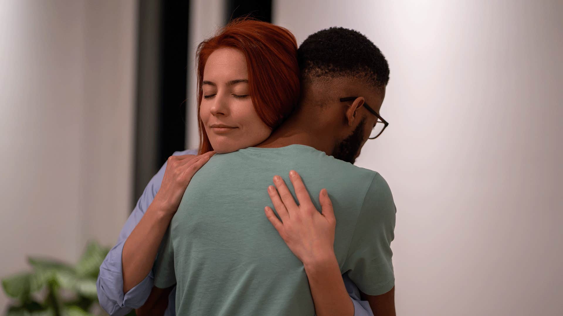 classy woman being empathetic and hugging man