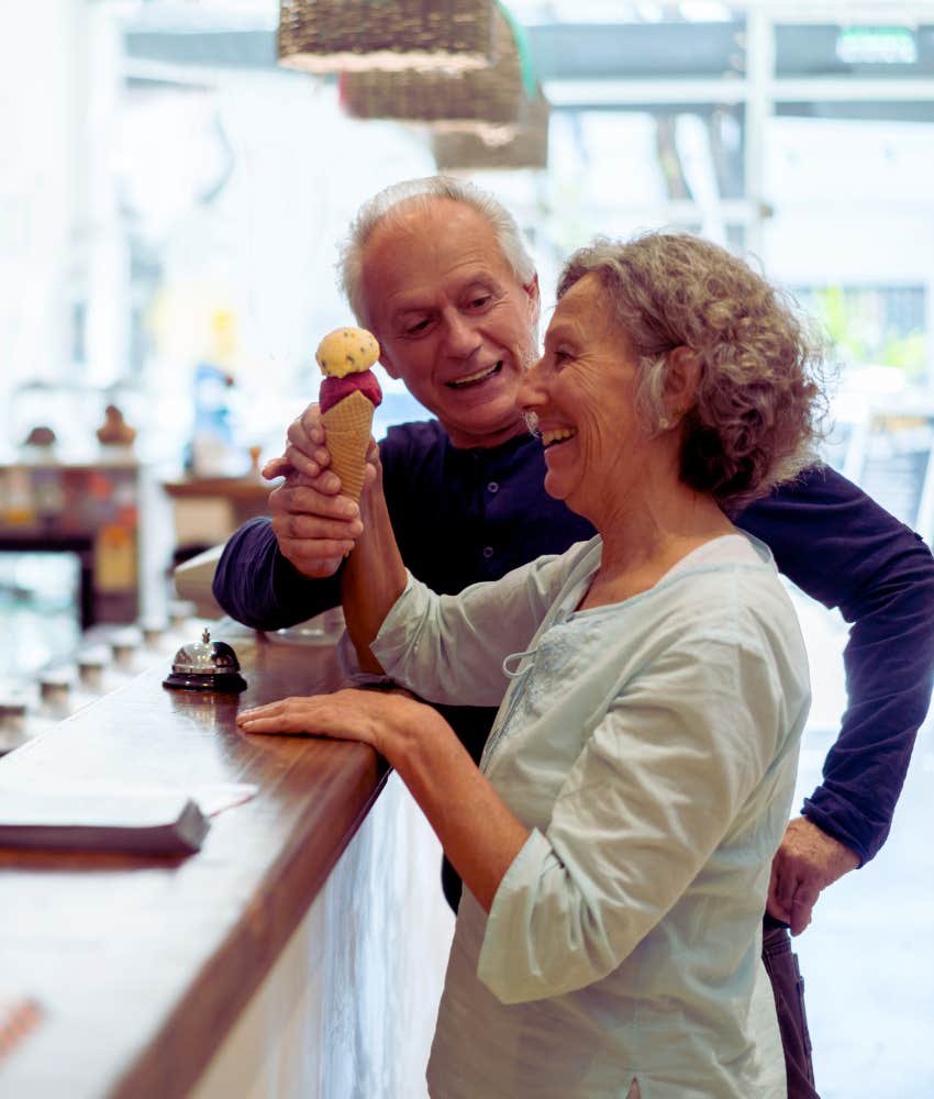 senior couple getting ice cream cones at ice cream shop