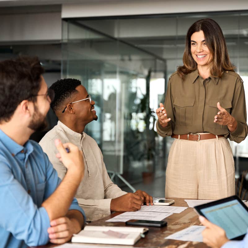 middle aged business woman discussing strategy working with diverse colleagues