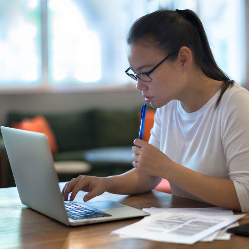 young women doing work on her laptop computer at home.