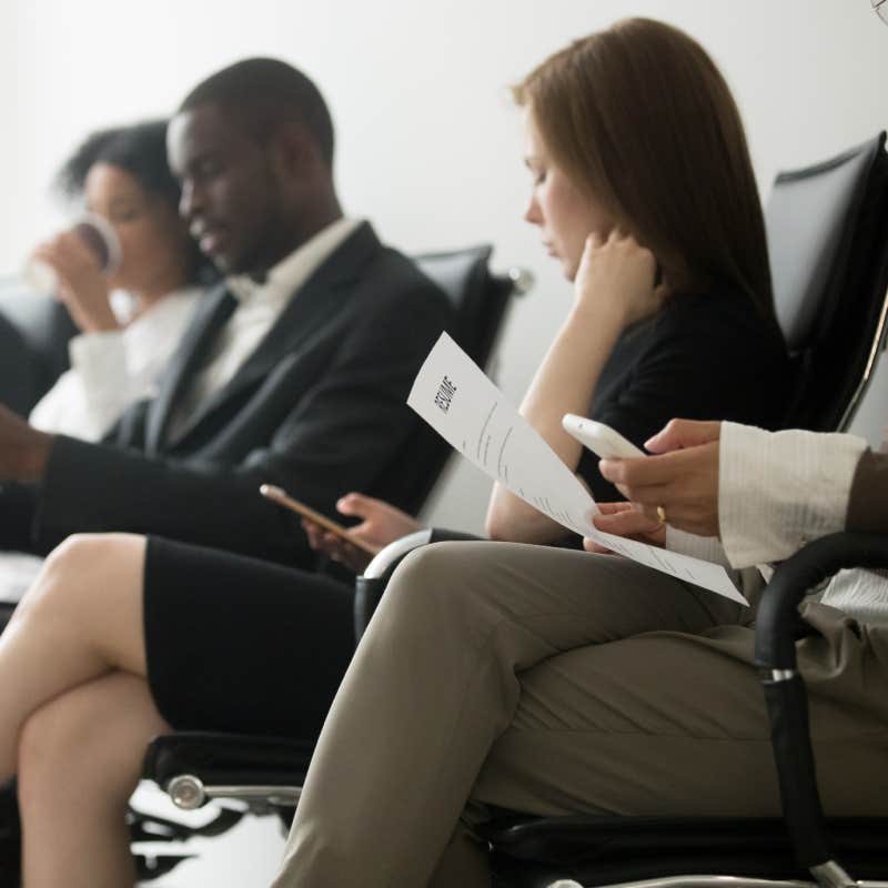 applicants sitting in queue preparing for interview