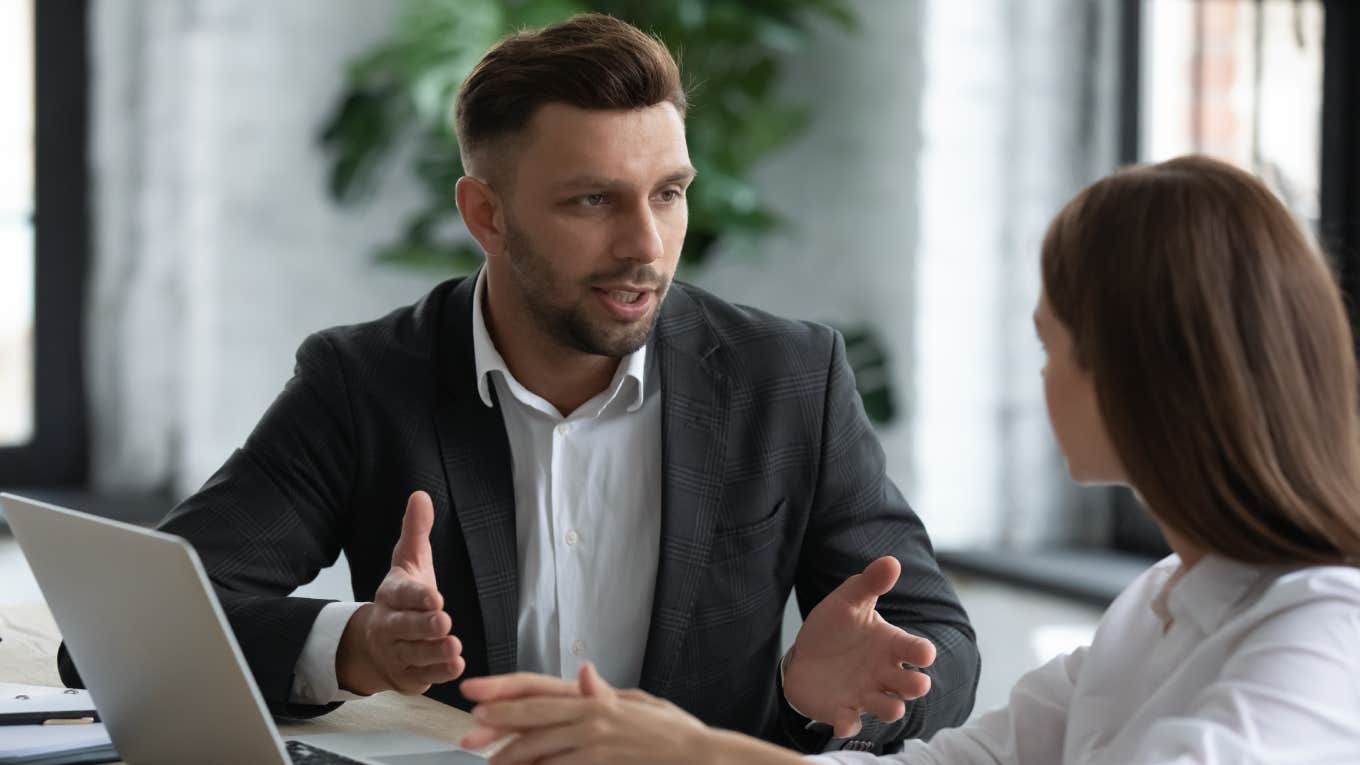 businessman talking with employee in boardroom at meeting