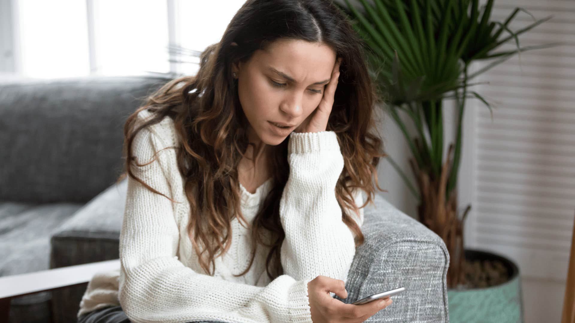 woman looking stressed and staring at phone