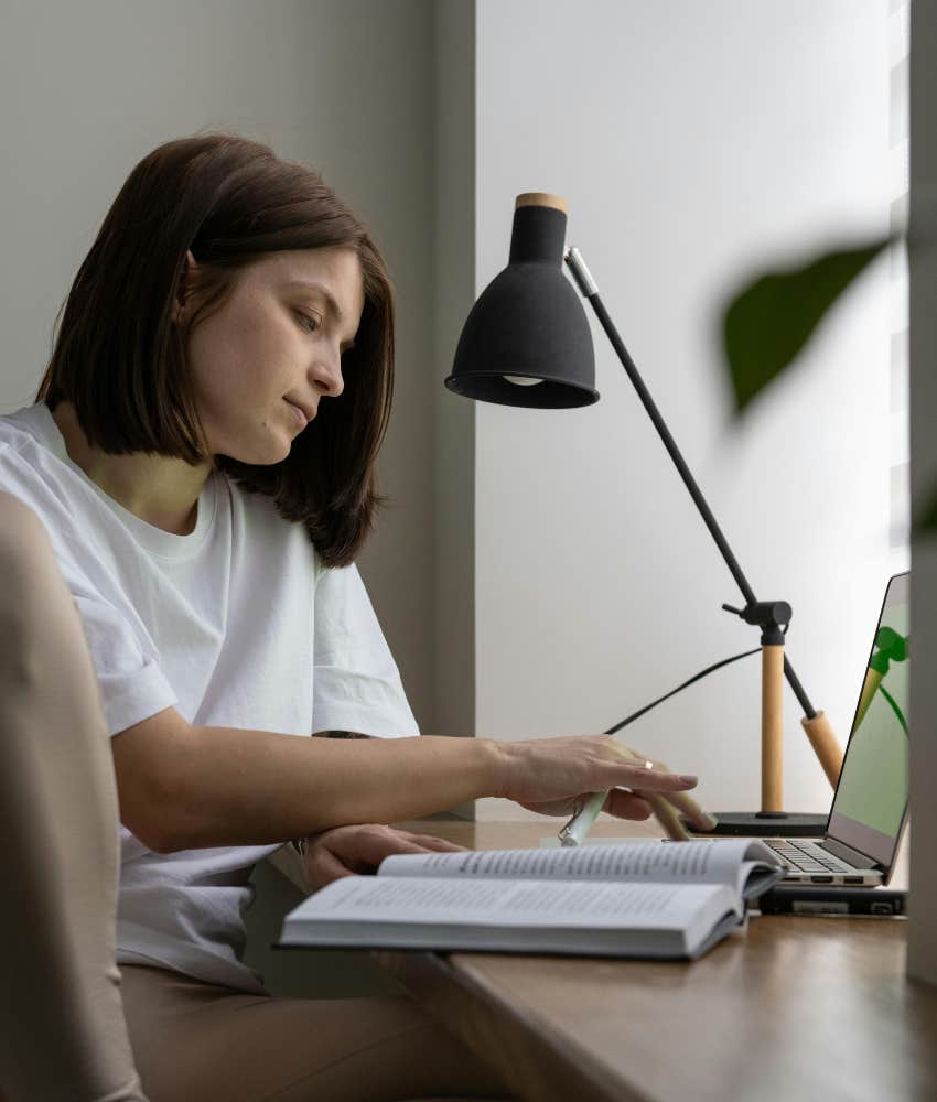 woman reading at a desk