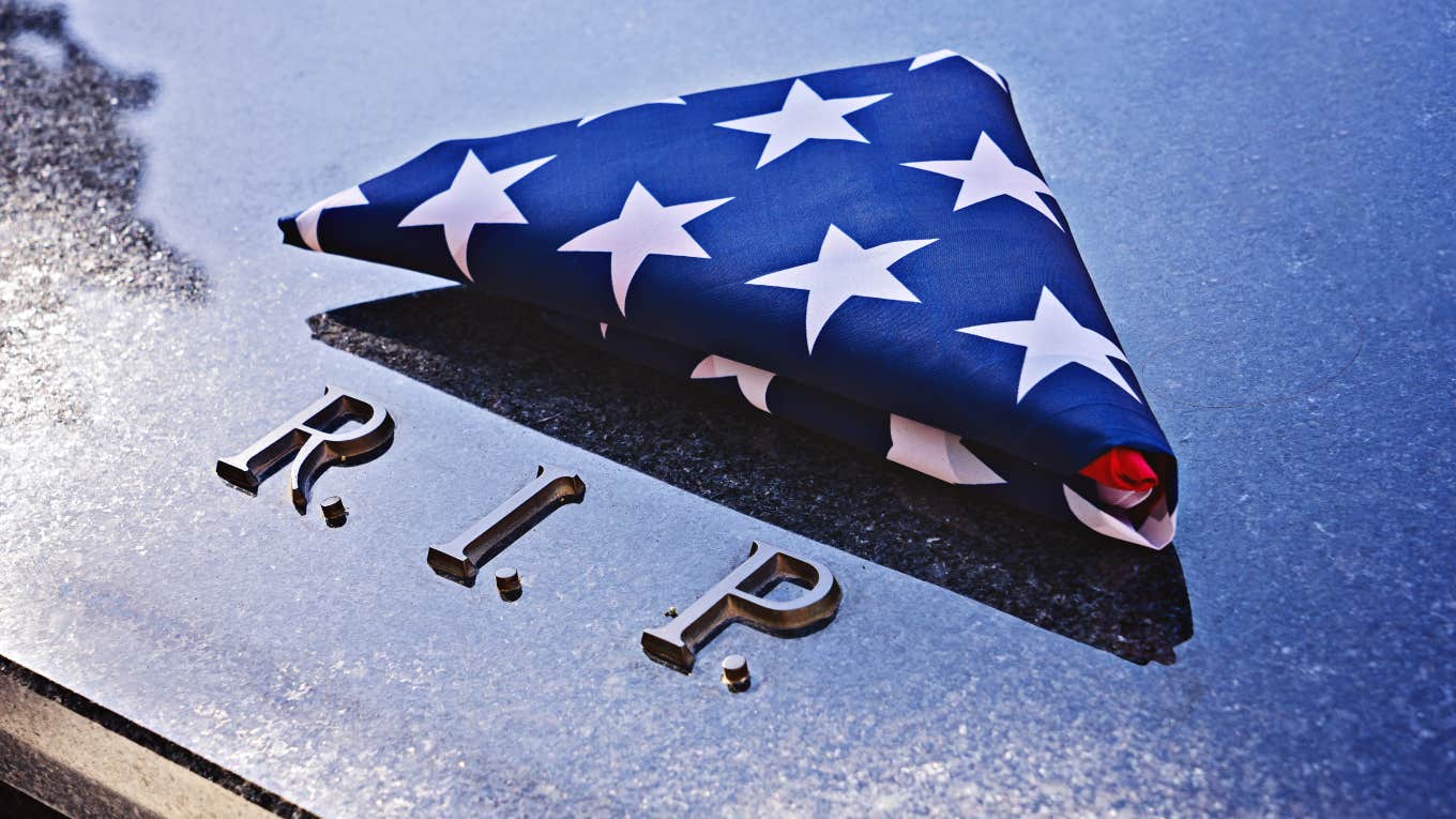 folded up American flag on veteran's memorial