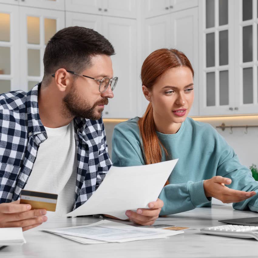 Couple looking confused at a mistake on their bills. 