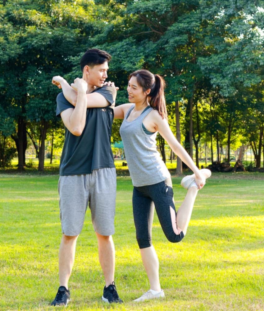 Couple stretching in the park