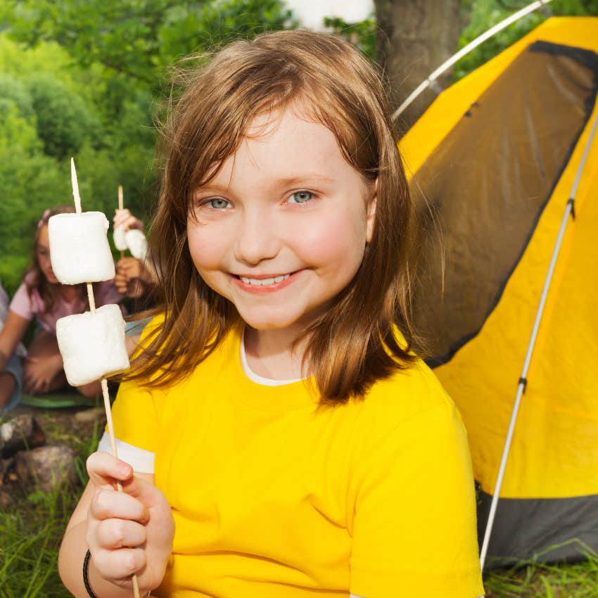 girl holding marshmallows at campfire