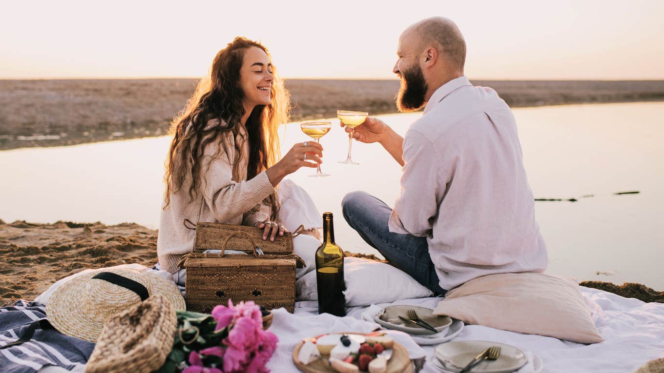 married couple having a fun date night picnic