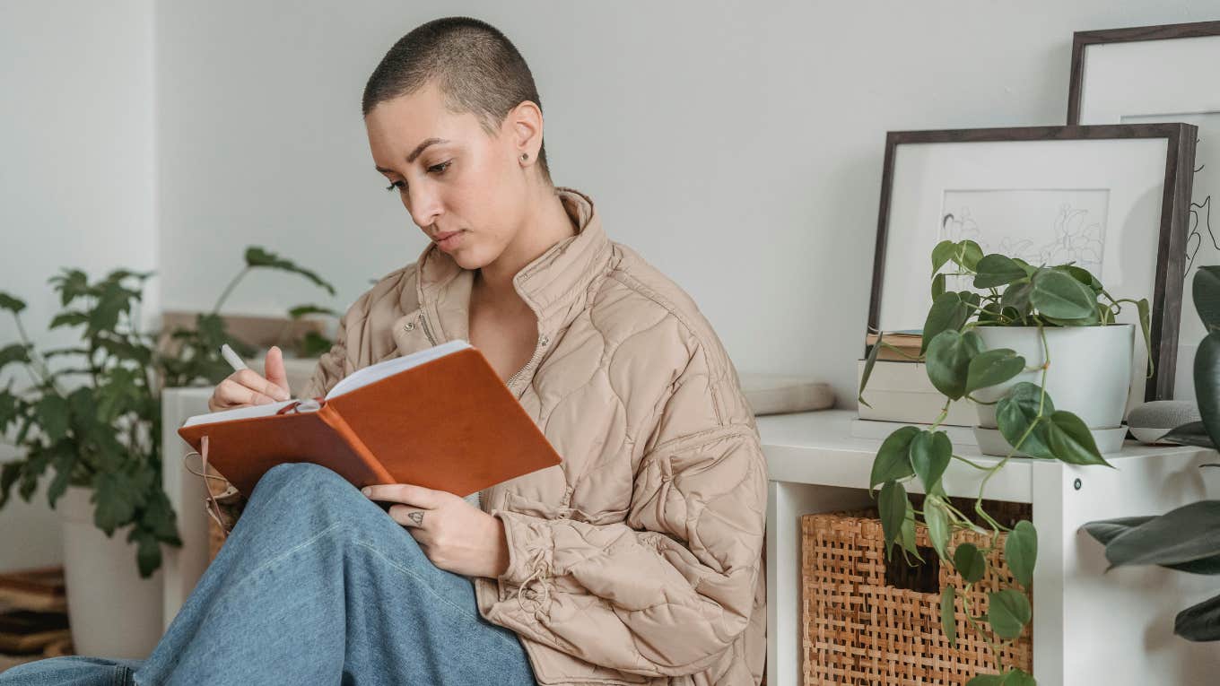 woman writing in journal 